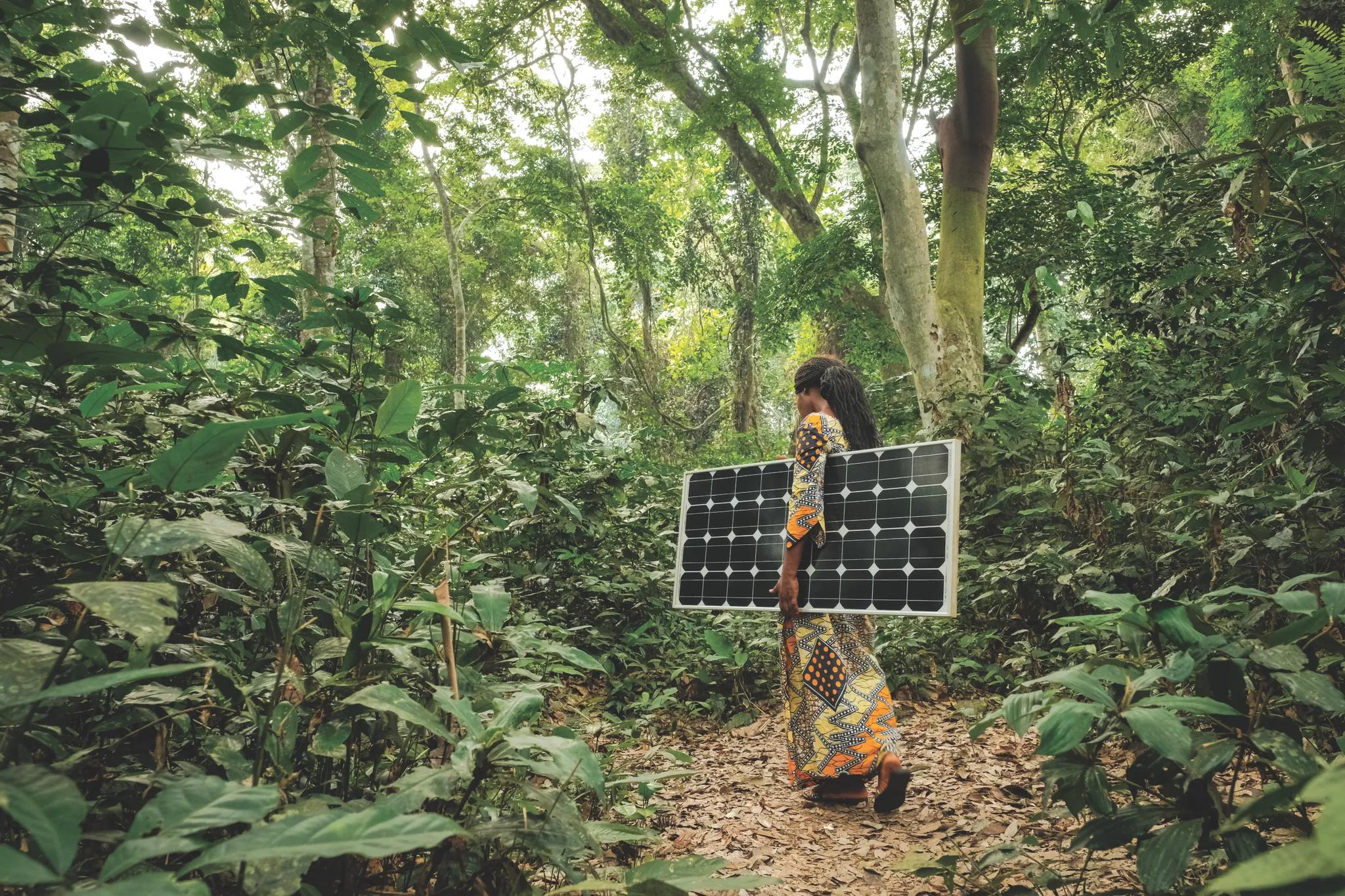 Woman carrying a solar panel